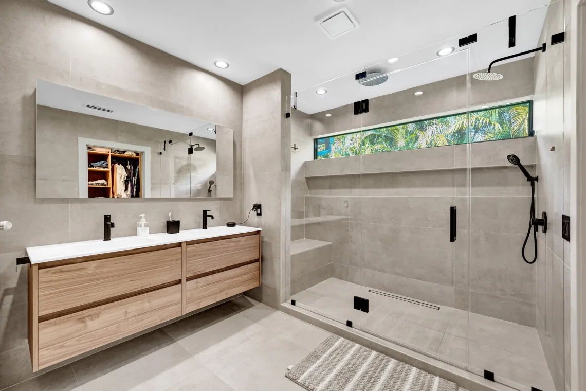 Master bathroom with floating wood double vanity and oversized frameless walk-in shower